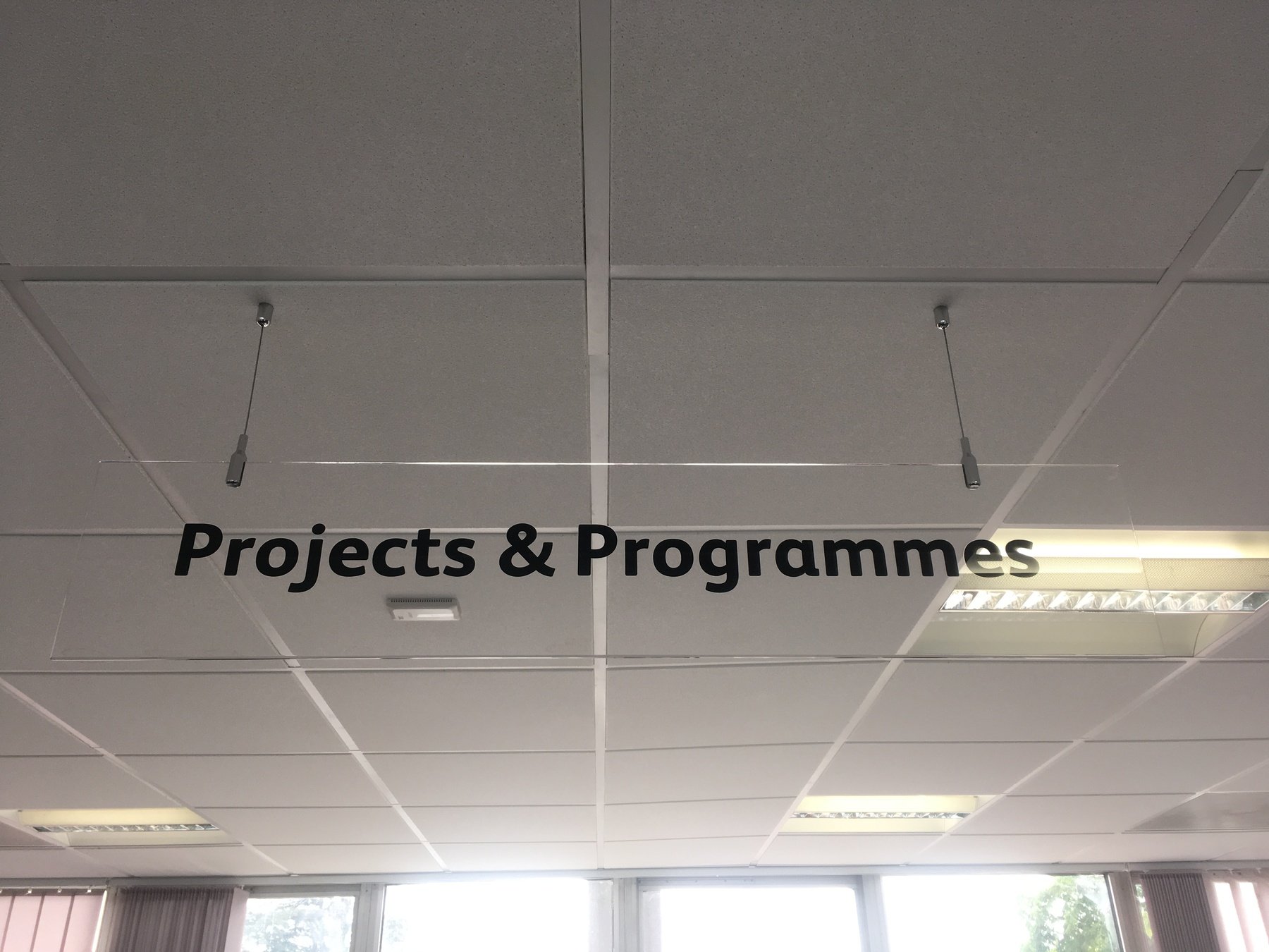 clear perspex hanging sign with wire and panels clamps
