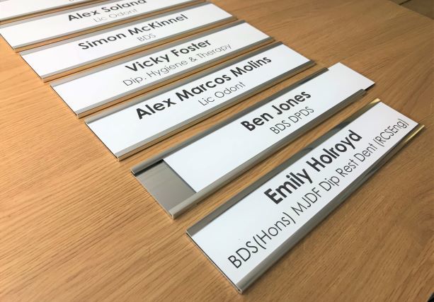 Interchangeable door nameplate holders
